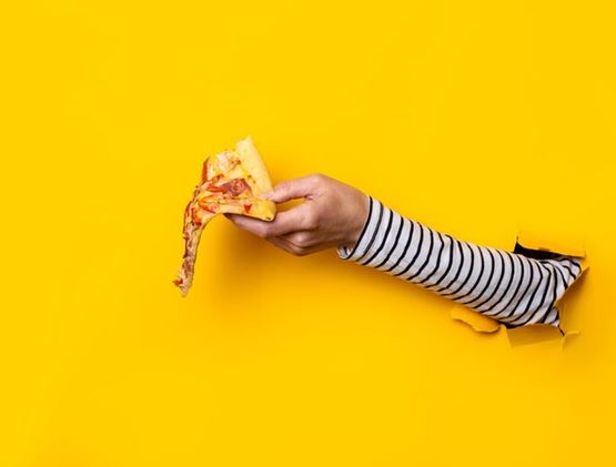 Hand through a wall, giving pizza piece