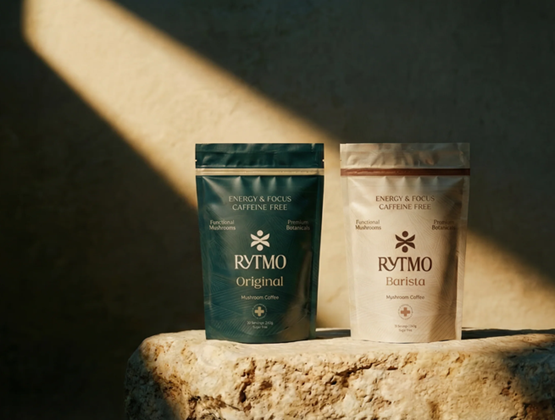 Two Rytmo mushroom drink pouches, Original and Barista, displayed on a stone block.