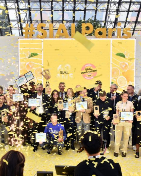 SIAL Innovation award ceremony with winners on stage surrounded by yellow confetti.
