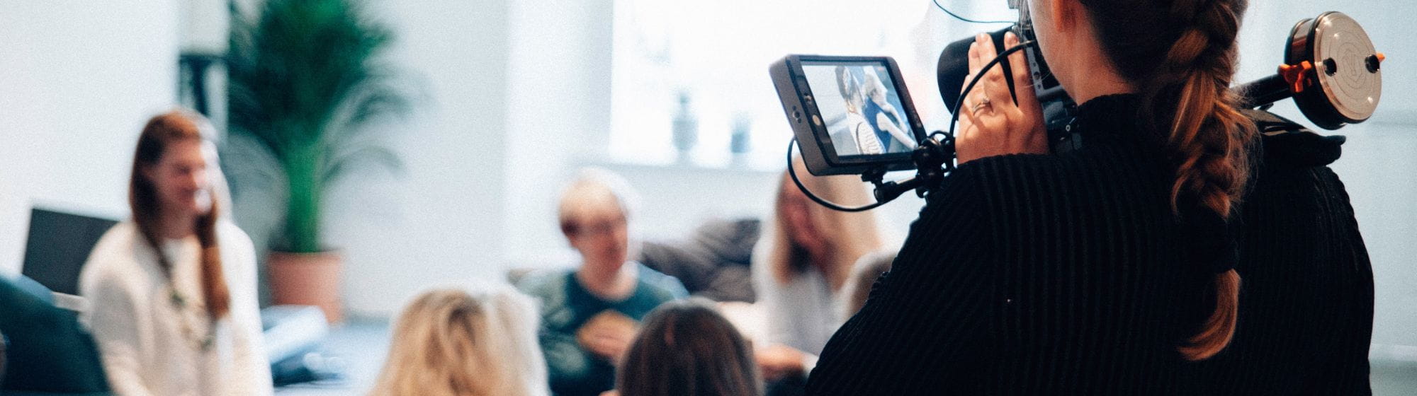 A woman filming a meeting