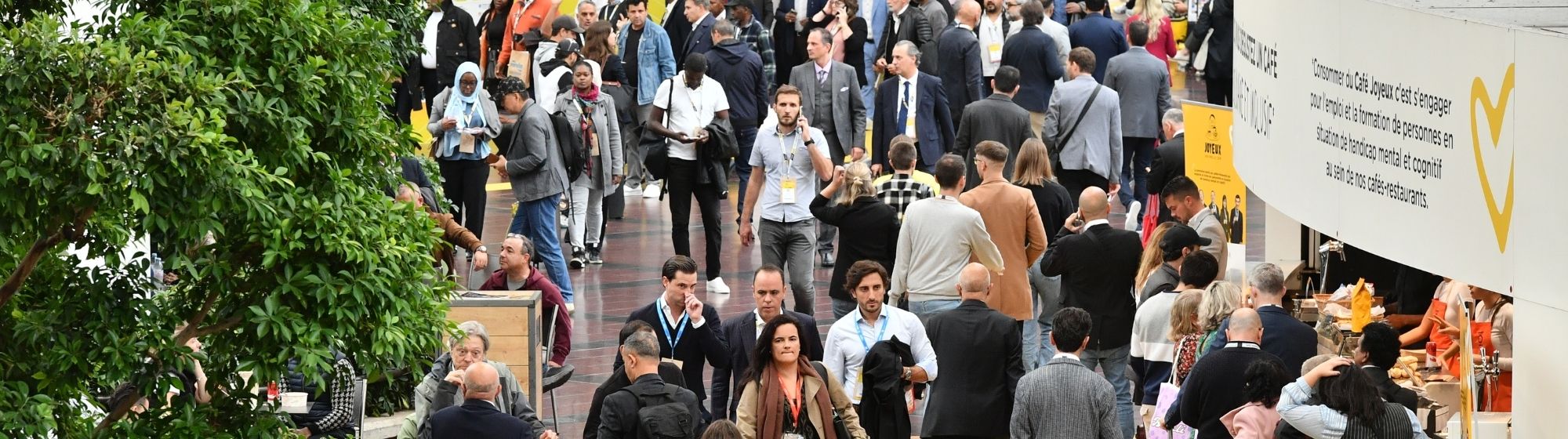 Panoramic view of a SIAL trade show aisle showing a high attendance of professional visitors and booths.