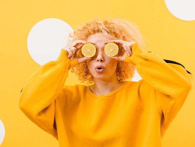 a woman plays with lemons