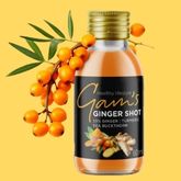 Ginger shot drink with ginger and turmeric shown in a bottle with fresh roots