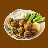 Plate of vegetable and seaweed fritters served with green vegetable sticks