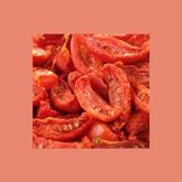 Sliced frozen tomatoes shown in close-up on a colored background