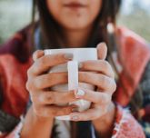 Girl with a hot drink between her hands