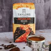 Taylors of Harrogate “Hot Lava Java” coffee beans bag with a cup of coffee in the foreground.