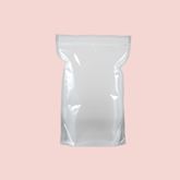 A blank white pouch with a sealed top, placed on a pink background