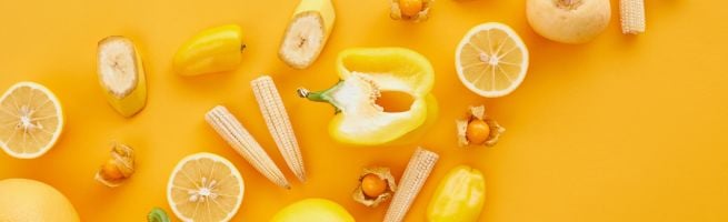 Yellow fruits and vegetables on a yellow table