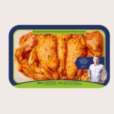 Marinated sliced chicken in packaging with a chef’s photo.