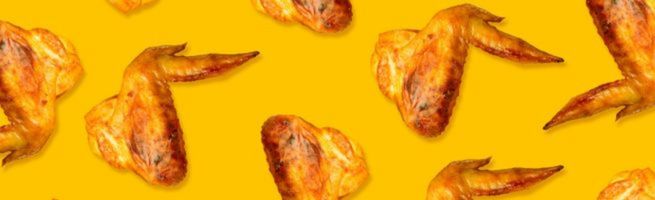 Roasted chicken wings arranged in a repeating pattern on a bright yellow background.