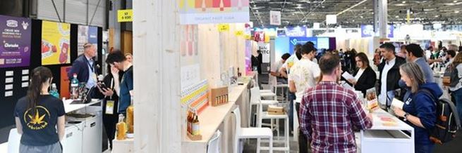Exhibitors and visitors interact at the SIAL Start-up Village with colorful booths