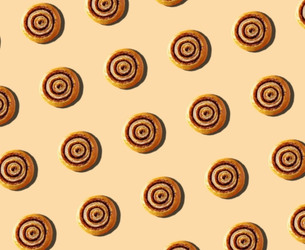 Repeating cinnamon roll pattern on a beige background, illustrated for a bakery-themed visual identity.