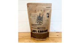 Dark roasted organic coffee "Lupi Coffee" packaging featuring lupin plant illustrations.