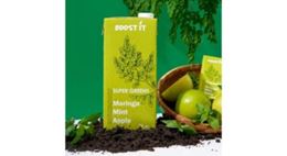 Super Greens drink made with moringa, mint, and apple, in green packaging, with apples and mint leaves.