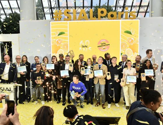 Winners of the SIAL Innovation Awards 2024 posing on stage with their trophies, surrounded by confetti.