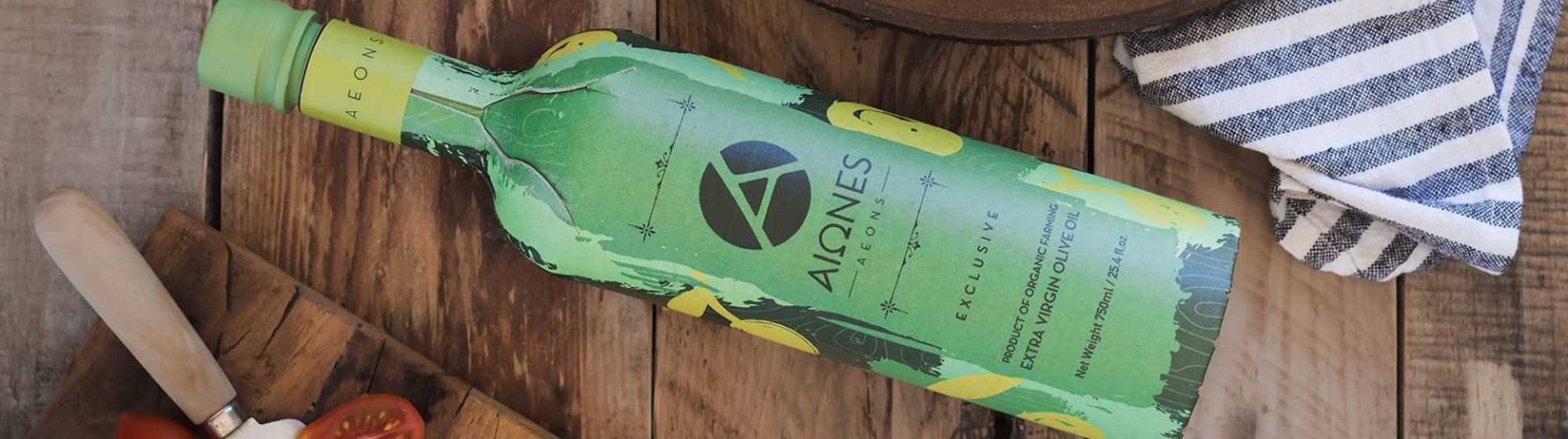 Green olive oil bottle with label and natural background.