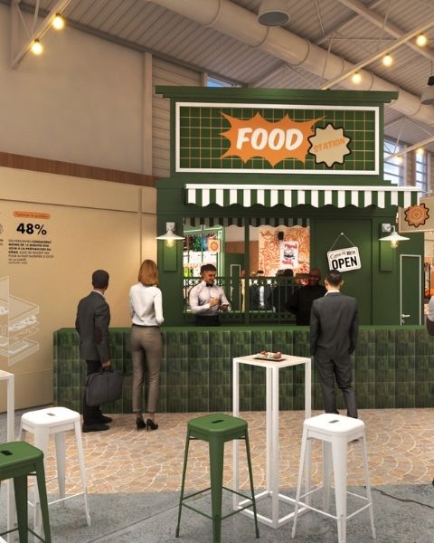 Blue Food Station booth in an event space, with service counter, stools and visitors waiting to order.