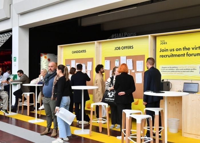 Recruitment area with job offer boards and candidates interacting during the SIAL Paris trade show
