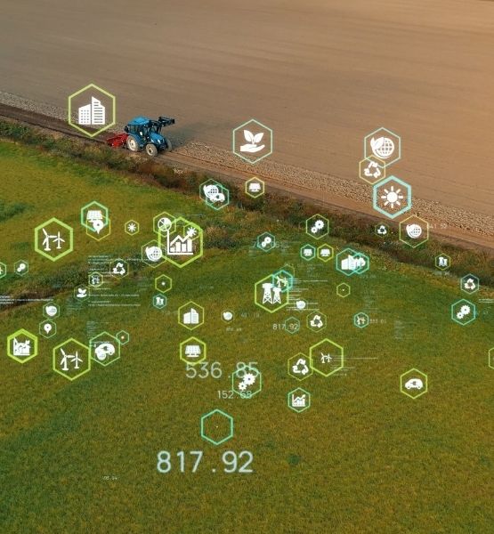 Farm tractor in field with digital interface and data icons illustrating smart and connected agriculture technology
