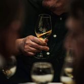 White wine glass with warm orange hues during a tasting experience