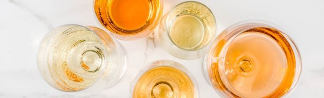 Top view of wine glasses with warm orange tones, elegant composition