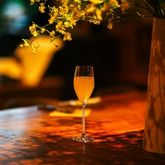 Orange wine glass on a bar counter, warm and intimate evening atmosphere