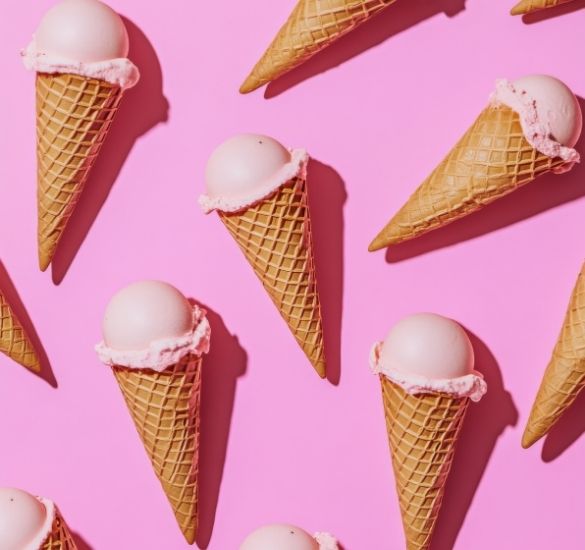 Ice cream cones arranged in a repeating pattern on a pink background.