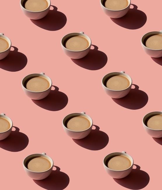 Fair trade coffee cups on pink background