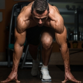 Muscular man preparing to sprint