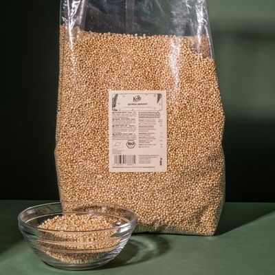 Bag of gluten-free puffed quinoa with grains displayed in a small bowl