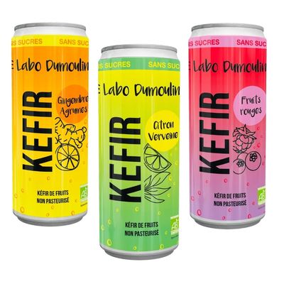 Assortment of colorful kefir bottles on white background