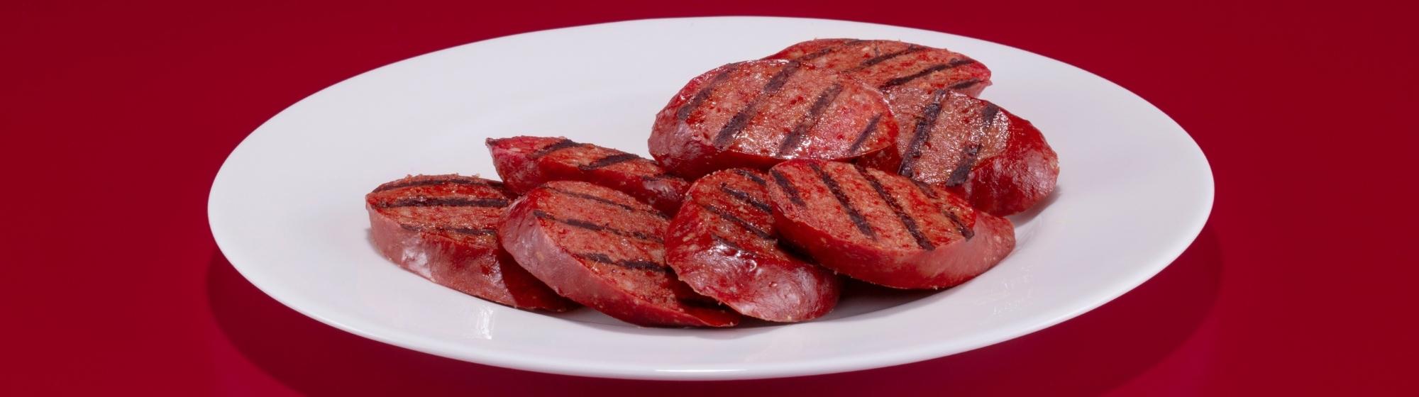 Sliced salami red background