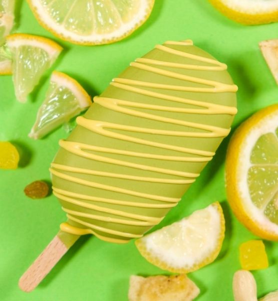 Lime ice cream bar decorated with citrus zest on a green background.