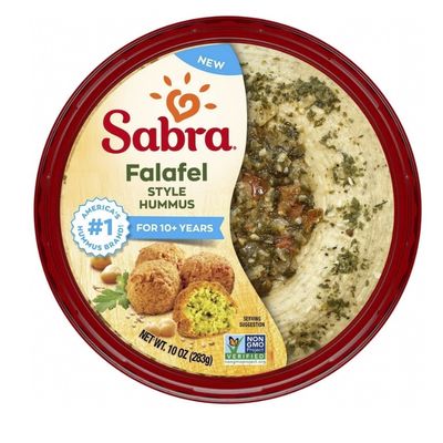 Sabra falafel style hummus in round tub with topping and chickpeas.